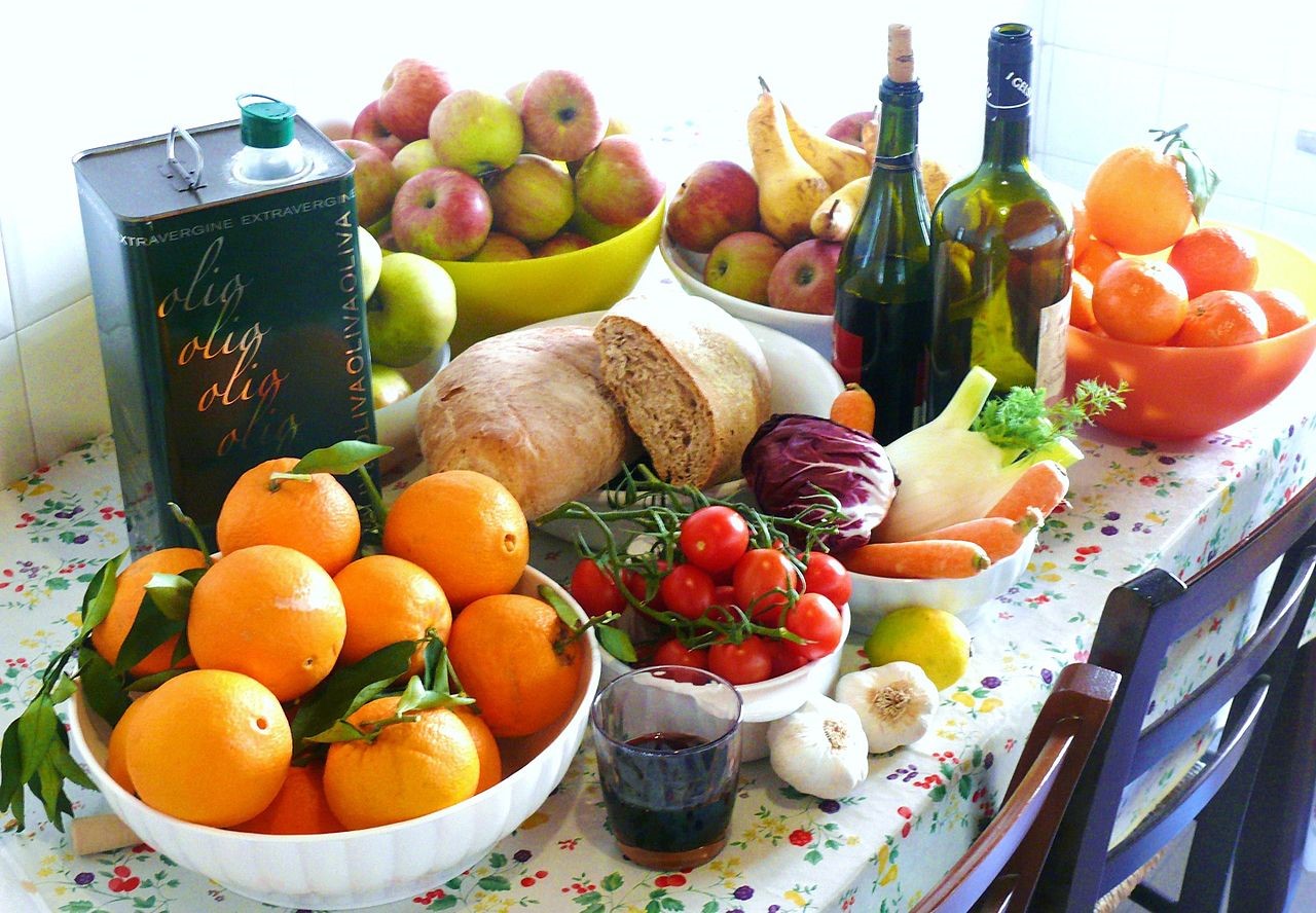 A spread of fruits, bread, olive oil, and wine. Photo by G.steph.rocket courtesy of wikimedia